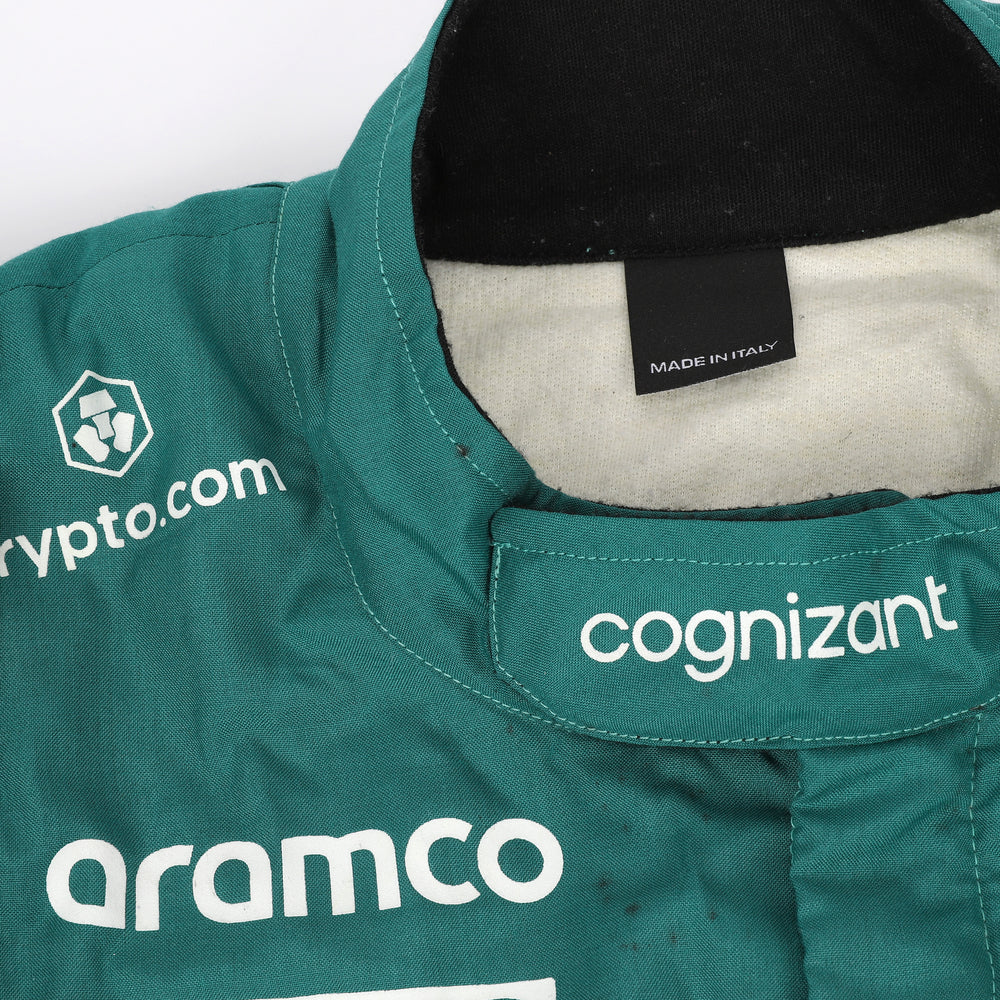 Close-up of the fabric and stitching on Fernando Alonso’s 2023 F1 racing suit, capturing the high-quality material and detailed sponsor branding, designed for durability and race-ready functionality.