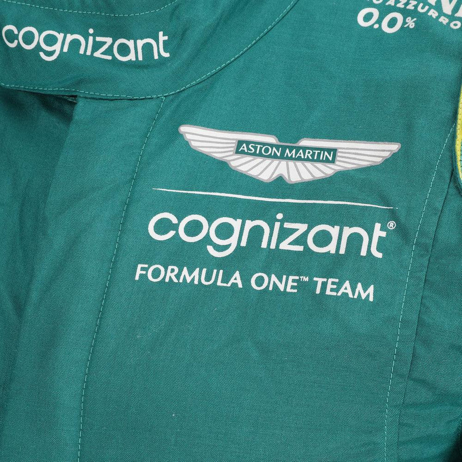 Close-up of the fabric and stitching on Fernando Alonso’s 2023 F1 racing suit, capturing the high-quality material and detailed sponsor branding, designed for durability and race-ready functionality.