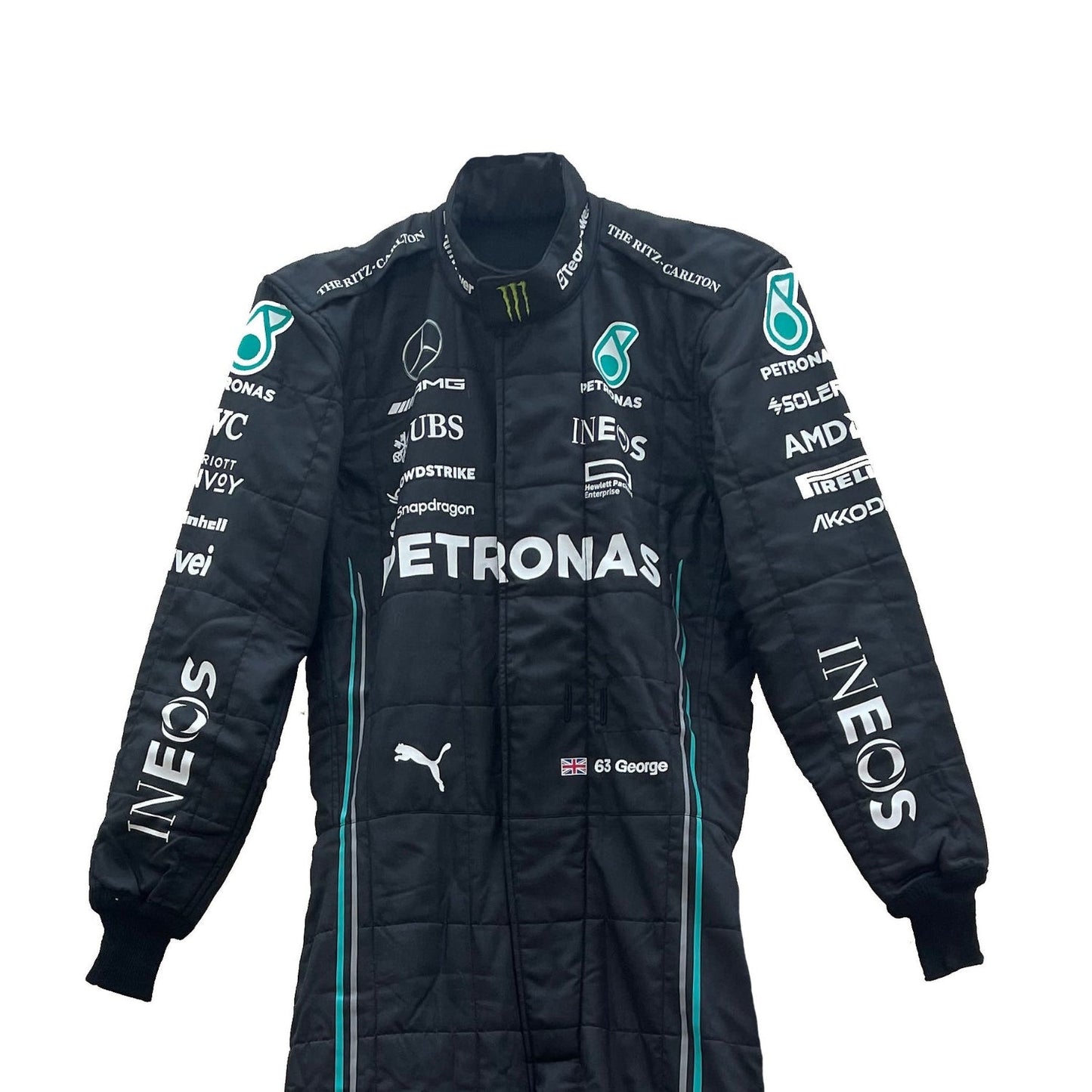 Close-up of the fabric and stitching on George Russell’s 2023 racing suit, revealing the intricate details and high-quality materials, with clear visibility of sponsor logos.