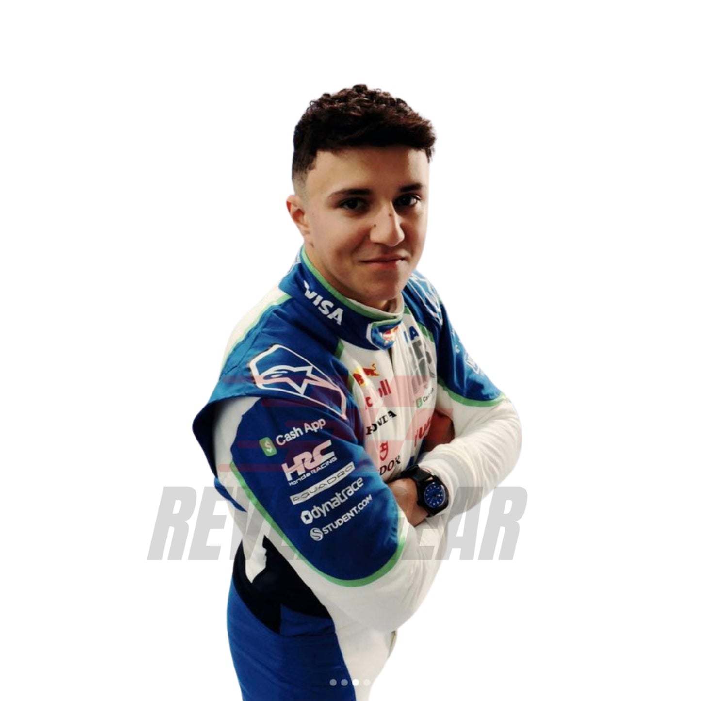 Isack Hadjar standing in his 2025 racing suit, showcasing the front design with blue and green accents.