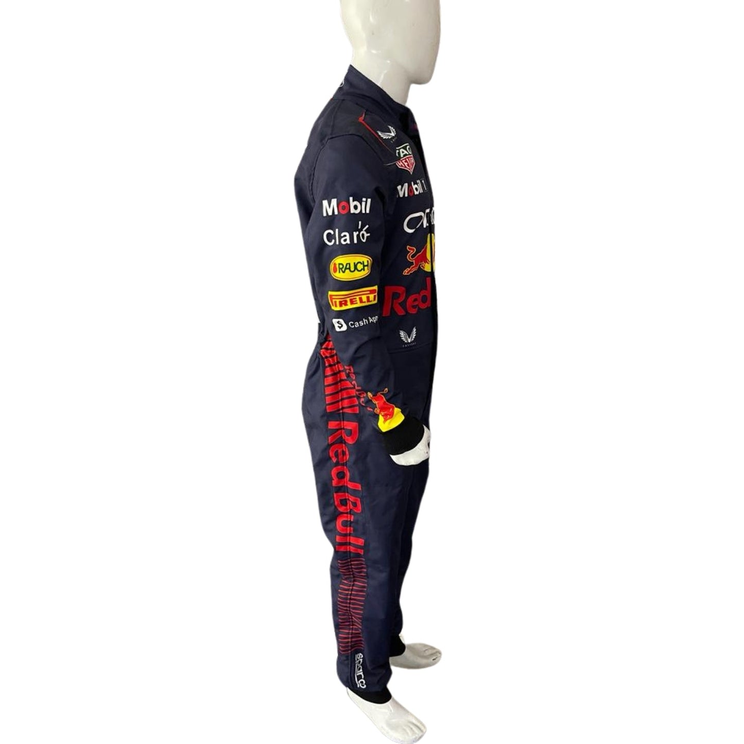 Side angle showing Verstappen’s navy blue race suit with dynamic red accents along the torso and yellow detailing around the sleeves.