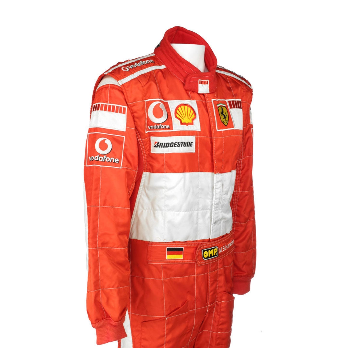 Side profile of the 2006 F1 suit worn by Michael Schumacher, featuring bright red fabric with sleek contouring and high-visibility white accents.