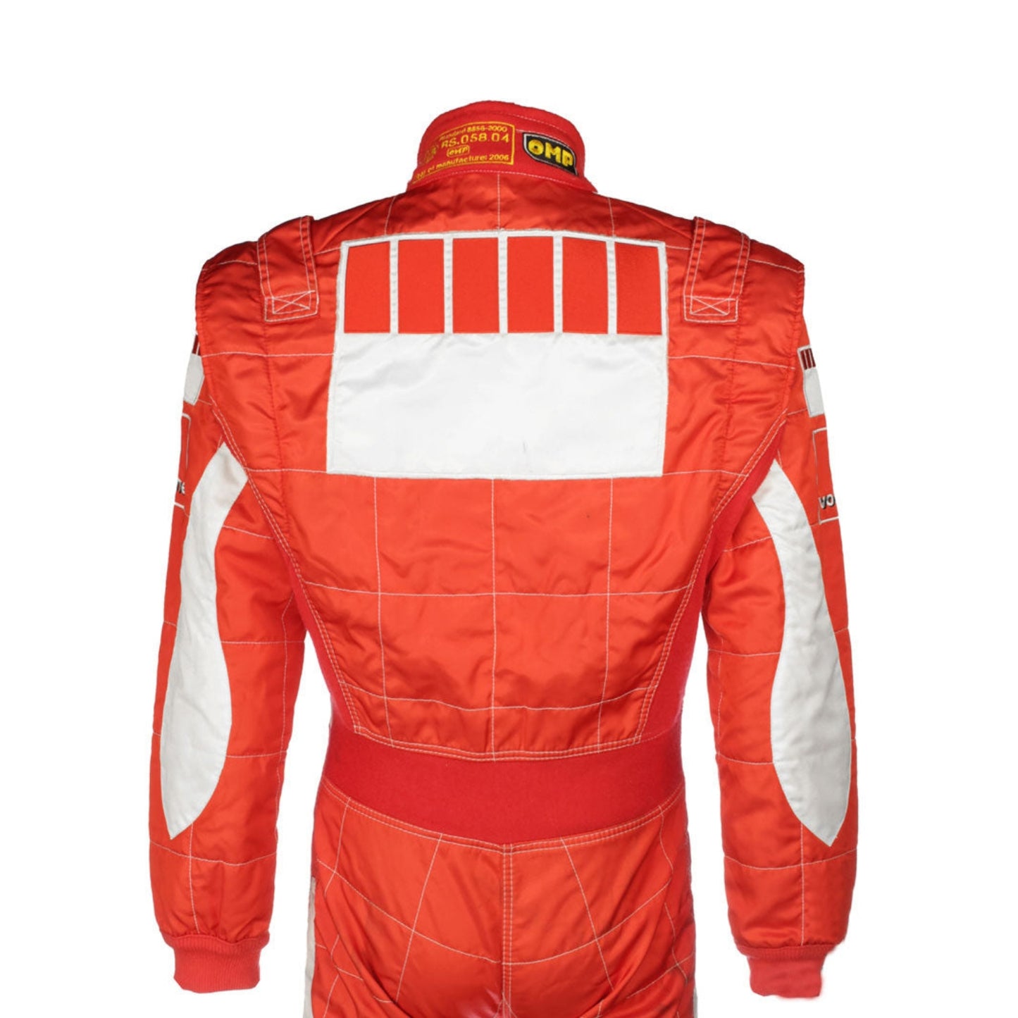 Close-up shot of Schumacher’s 2006 race suit, highlighting the detailed stitching, premium red material, and signature white branding elements.