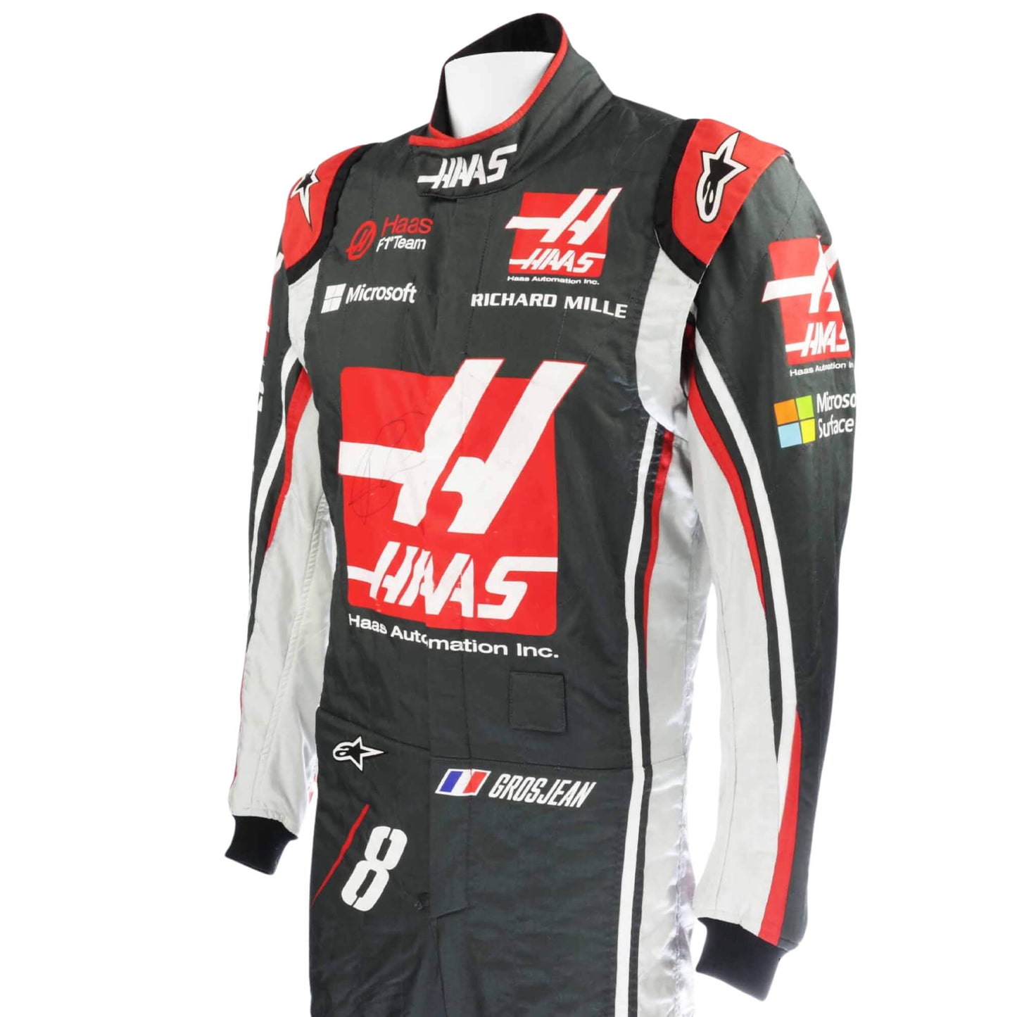 Close-up of the sleeve on Romain Grosjean’s 2017 F1 racing suit, featuring embroidered sponsor logos and high-performance construction.