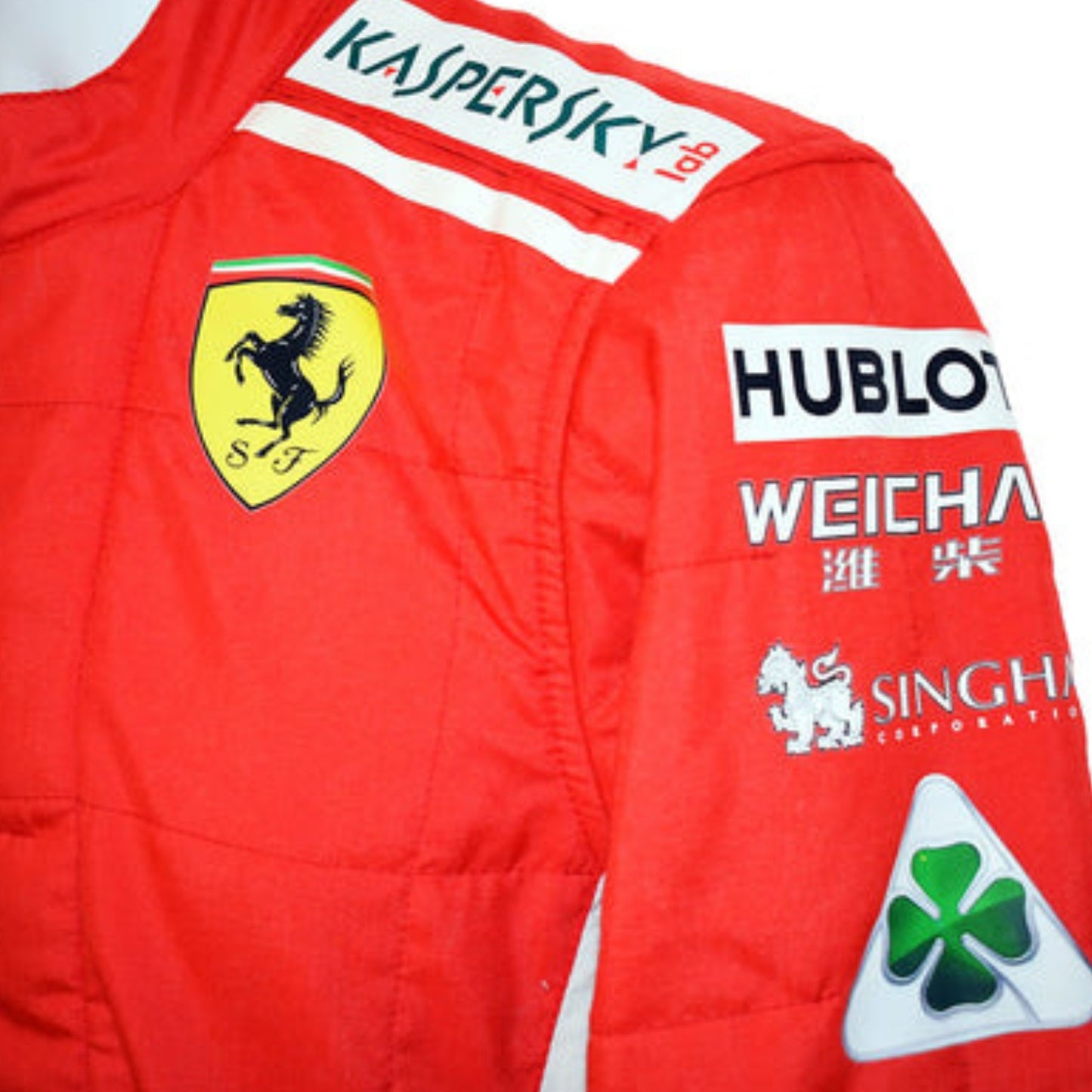 Side profile of Sebastian Vettel’s 2018 F1 racing suit, highlighting the bold red fabric with streamlined white sponsor graphics.