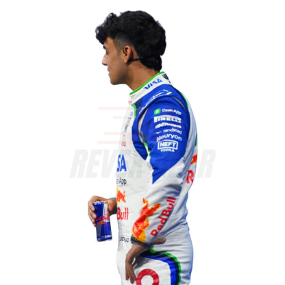 Arvid Lindblad wearing a racing suit with various sponsor logos, holding a Red Bull energy drink can.