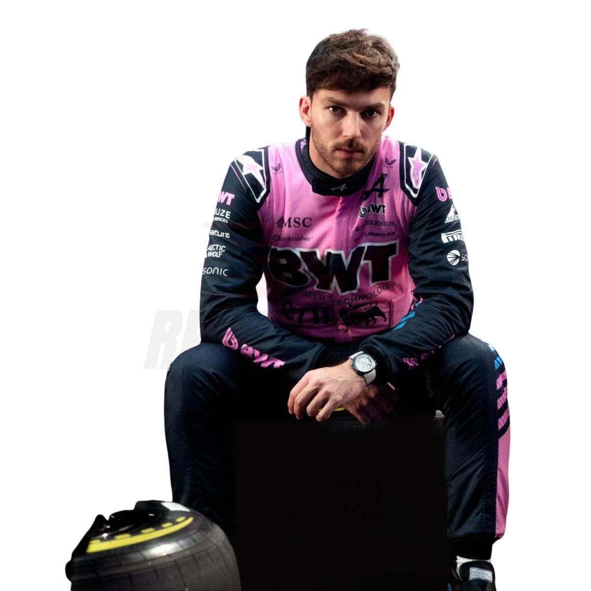 Pierre Gasly wearing a pink and black racing suit with visible branding, sitting on a racing tire.