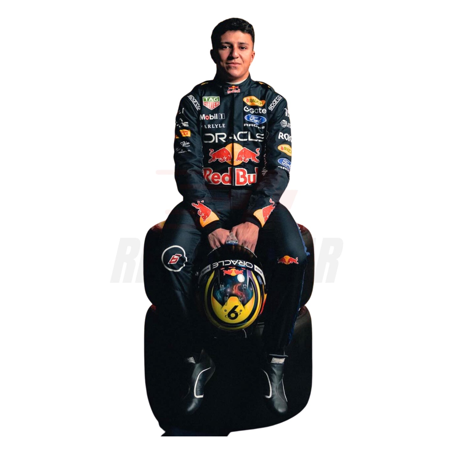 Isack Hadjar 2026 blue F1 racing suit front view with race number and sponsor logos wearing a Red Bull racing suit sitting on a racing simulator chair - Revex Gear