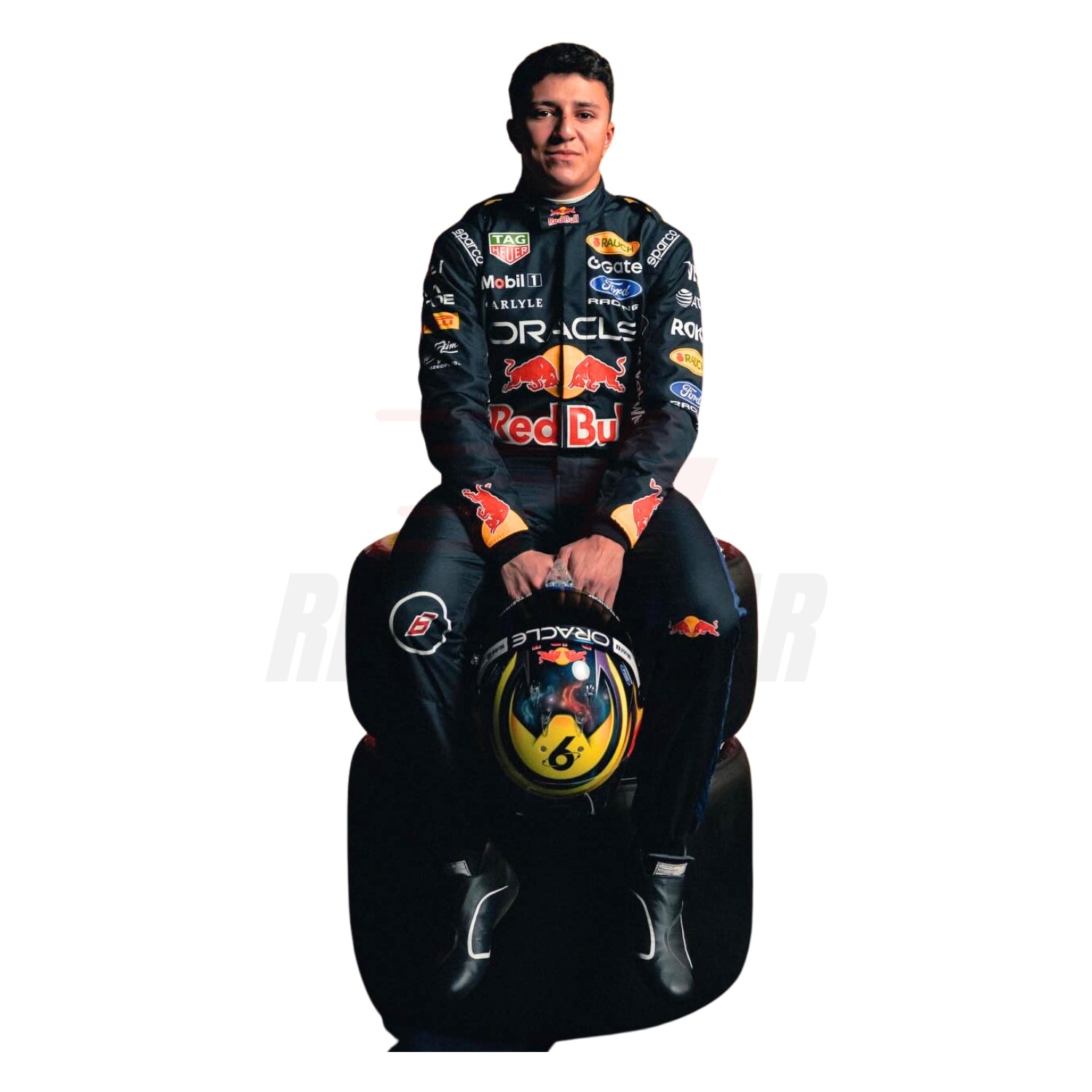 Isack Hadjar 2026 blue F1 racing suit front view with race number and sponsor logos wearing a Red Bull racing suit sitting on a racing simulator chair - Revex Gear