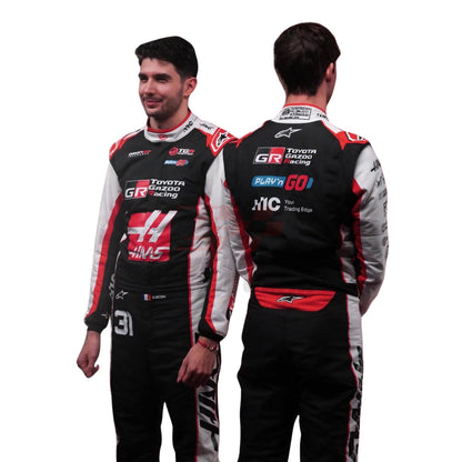 Esteban Ocon and Oliver Bearman wearing 2026 F1 racing suits and psoing for F1 racing Suits shoot