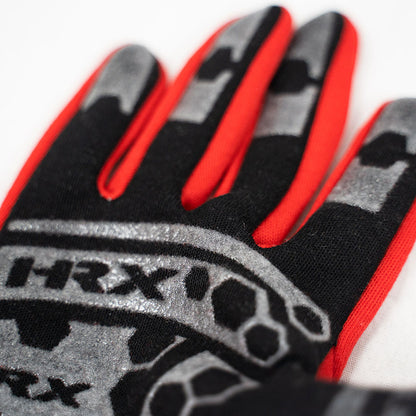 Close-up of a glove with red, black, and gray design on a white background