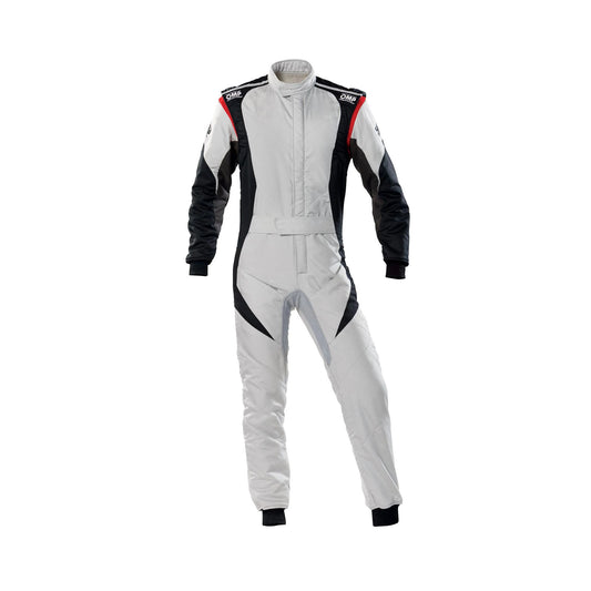 A gray OMP Tecnica Evo Race Suit with red and black accents, designed for competitive drivers, featuring a full zipper, elasticated cuffs, and a fine and soft collar.