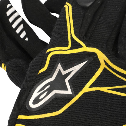 Kevin Magnussen 2016 Black F1 Racing glove with yellow accents and a star logo on a white background