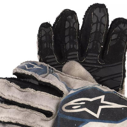 Close-up of a black and gray Lance Stroll 2017 F1 Racing glove with a brand logo on a white background