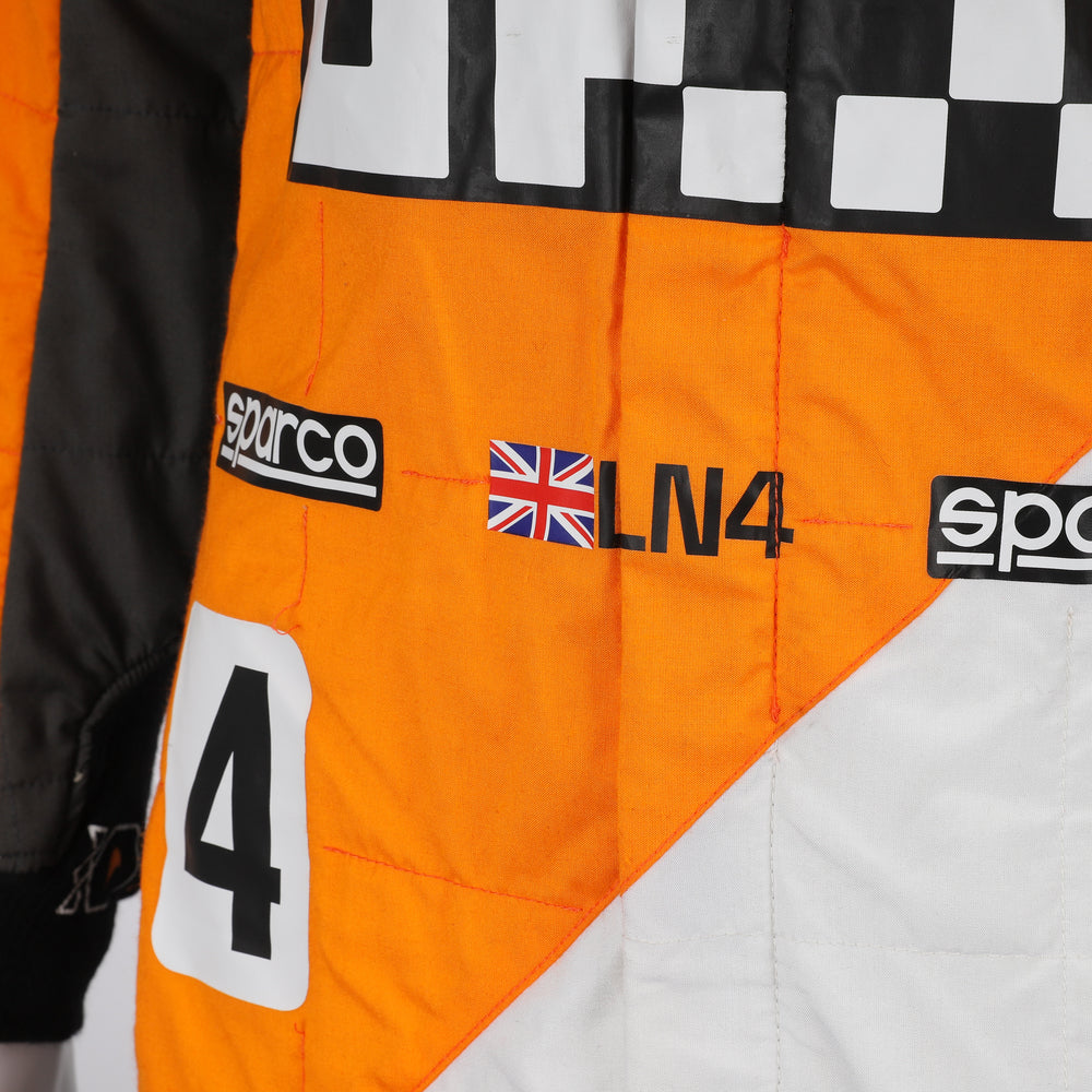 Close-up of the special edition Spanish GP racing suit showcasing premium fabric texture and subtle commemorative graphics.
