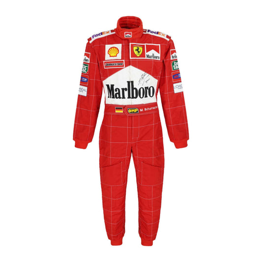 Front view of Michael Schumacher’s 2002 F1 race suit in red, featuring white accents and sponsor logos, marking his dominant championship-winning season.