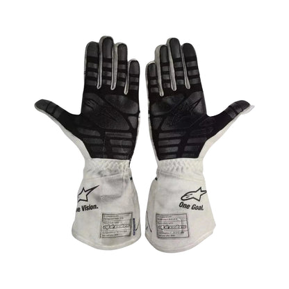 Pair of black and white Pierre Gasly 2020 F1 racing gloves with visible branding on a white background