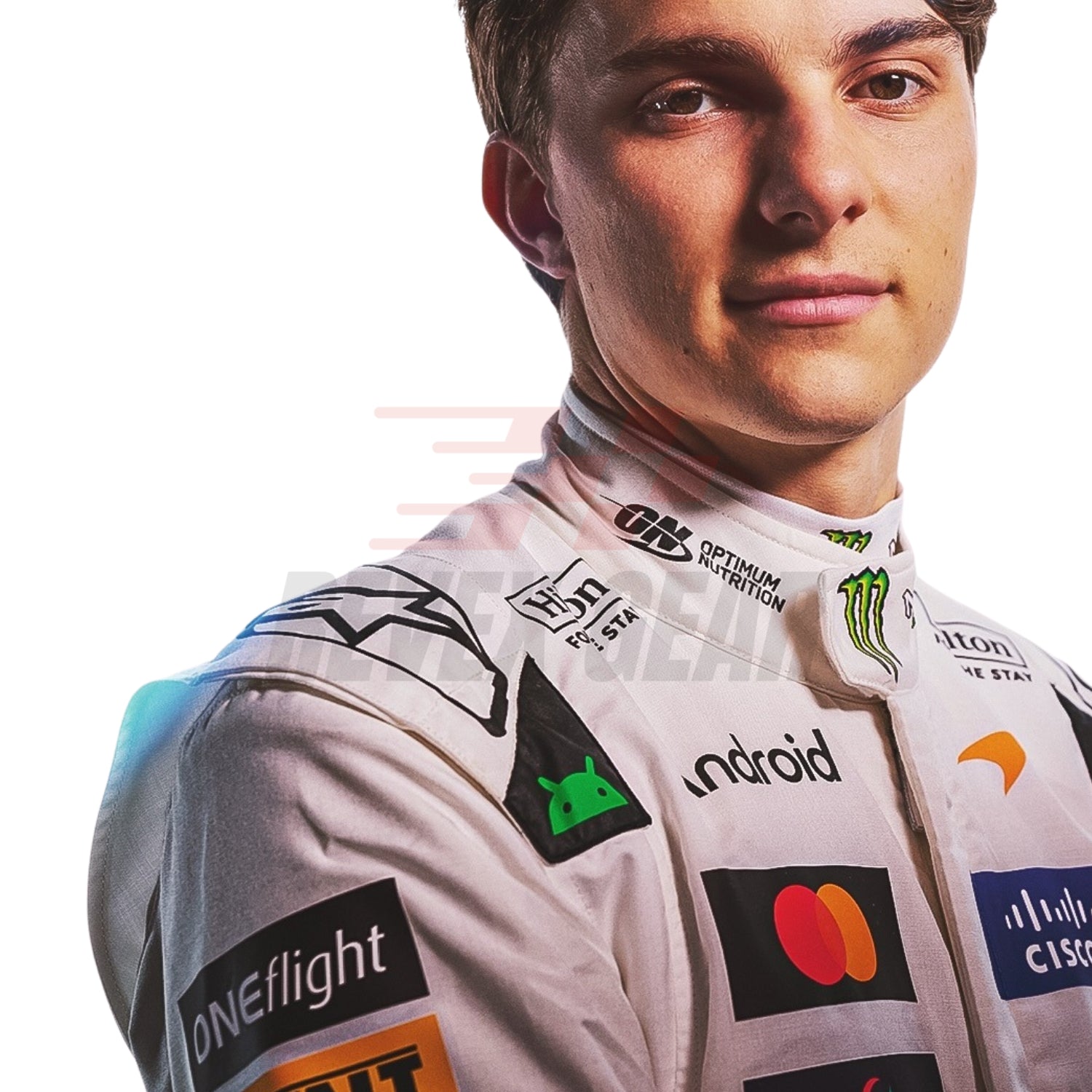 A close-up portrait of a male race driver, Oscar Piastri, wearing a McLaren 2026 British GP white F1 racing suit covered in sponsor logos, including Android, Mastercard, Optimum Motion, and Monster Energy, against a plain white background.
